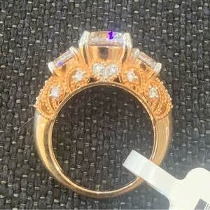 Gorgeous 3 stone ring in designer setting . Plated in 14k rose gold size 8